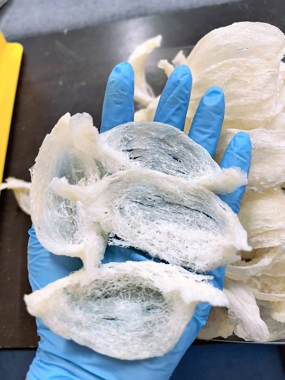 Gloved handling of fibrous nest material